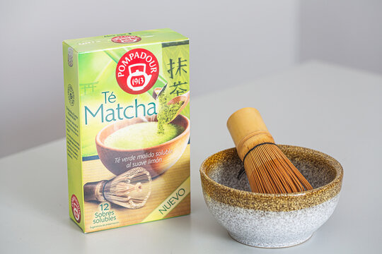Alicante, Spain - April 25, 2026: Matcha tea packaging with a bamboo whisk and ceramic bowl on a light surface, showcasing the product and preparation tools