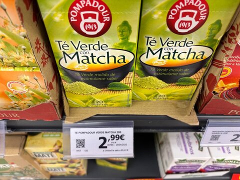 Alicante, Spain - April 25, 2026: Pompadour green tea with matcha displayed on a supermarket shelf, price tag visible, packaging features vibrant green design and product information