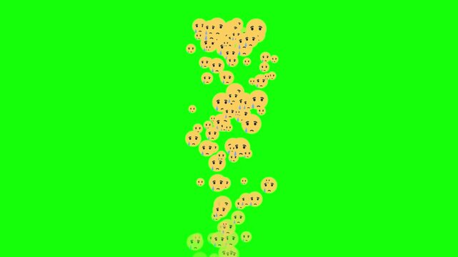 Yellow sad emojis cookies fall against green screen