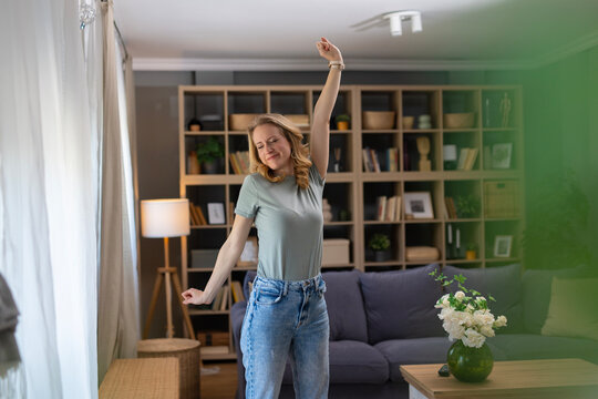 Woman dancing freely at home feeling joy and relaxation
