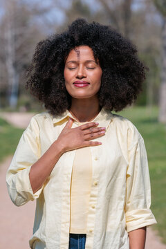 African woman practices grounding pose and breathing