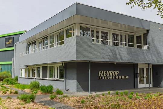 Veenendaal, Netherlands, April 15, 2026. Close-up view of the Fleurop Interflora Nederland headquarters, showing the gray brickwork and minimalist corporate design.
