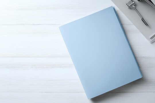 A single blue medical folder on a white desk, top-down view, plenty of empty desk space around it