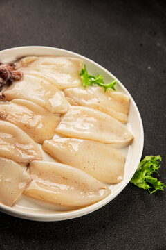 Raw squid fresh seafood marinated tasty snack fresh, delicious, gourmet food background on the table  rustic food top view copy space pescetarian diet