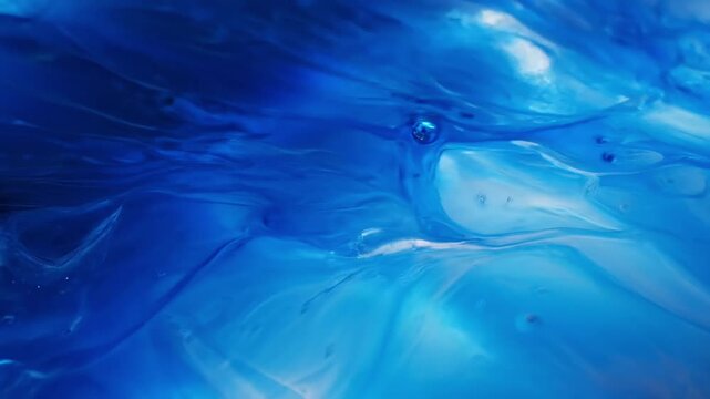 Blue liquid, abstract background, shiny surface, wave pattern