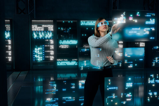 Programmer woman interacting with multiple code screens in 3D server room