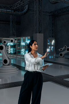 Technical woman operating holographic controls in 3D industrial facility