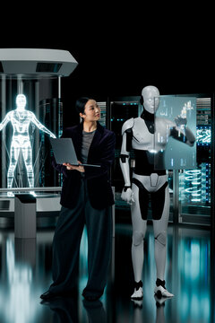 Engineer asian woman collaborating with humanoid robot on holographic interface in 3D lab
