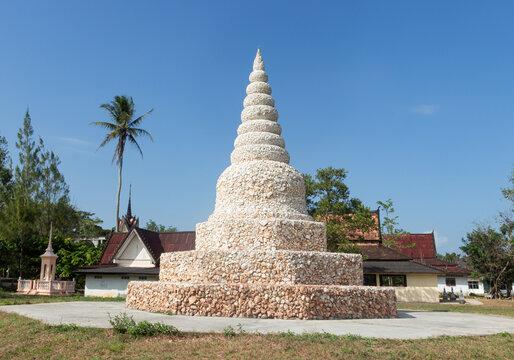 SONGKHLA, THAILAND - FEBRUARY 7, 2015: A beautiful and unique white stone or shell-decorated pagoda stands prominently in the courtyard of a local Buddhist temple in Bang Klam district.