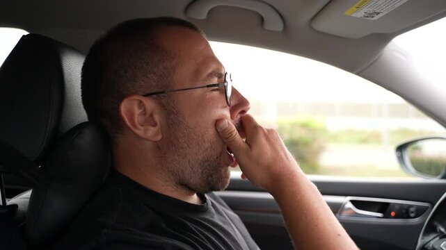 Tired driver yawning in car sleepy man driving fatigue