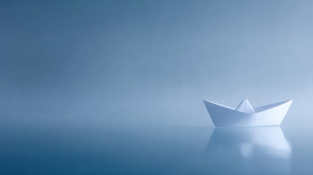 Lonely white paper boat drifting on calm blue water with mist, minimal emotional concept