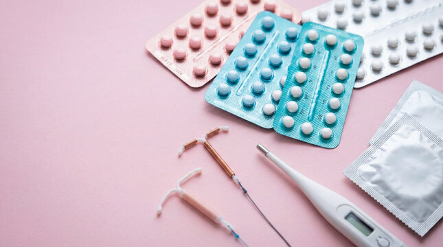 Various birth control methods including pills, IUDs, condoms, and a thermometer on a pink background