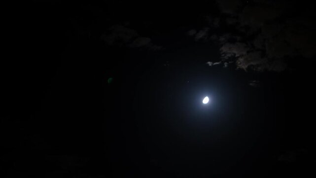 Timelapse of Moon and Clouds Moving Across Night Sky. Cinematic Moon and Clouds Motion in Night Sky. Astrophotography Moon and Clouds Timelapse Scene.