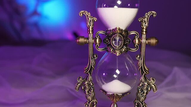Vintage sand clock decorated with forged monograms