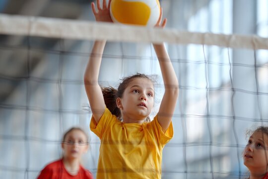 Young girl serves volleyball during indoor game practice