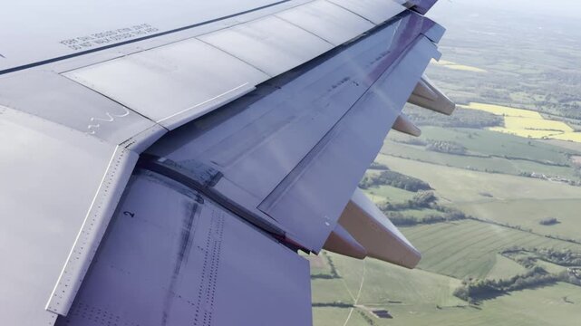 Jet descending towards green countryside 4K