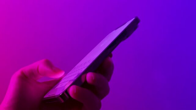 close-up shot of hands typing on a smartphone