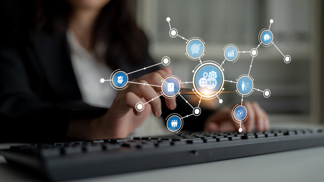 A business professional engages with a digital interface showcasing key performance indicators, reflecting analysis and strategy in a modern office environment. Tessel