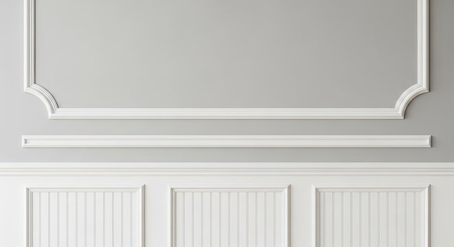 Elegant white molding on a light gray wall with decorative wainscoting panels below