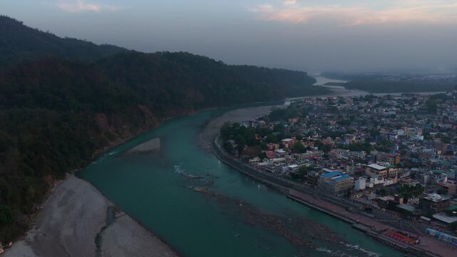 Aerial view of rishikesh showing houses, ganga river and mountains, 4k footage