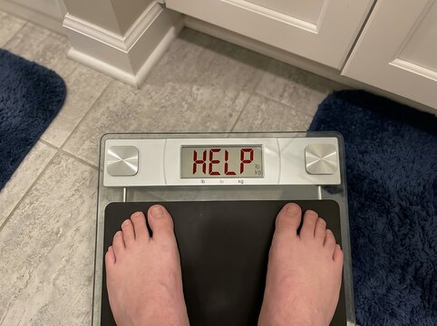 Scale with HELP reading addressing diet obsessive overweight conditions
