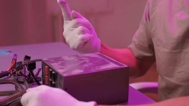 Technician cleaning computer. Expert cleaning and examining computer hardware meticulously. Technician carefully clearing dust from open computer with specialized tools