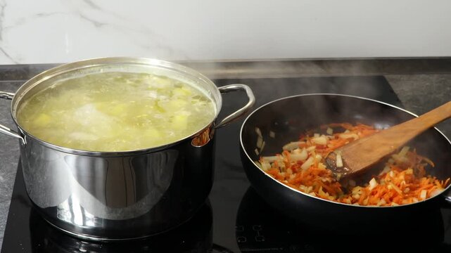 Cooking process showing vegetables sauteing in a pan while a pot of soup simmers on the stove, steam rising from both, creating a warm kitchen atmosphere