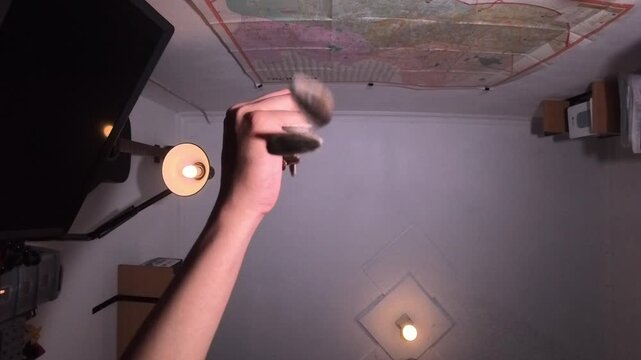 Clenched fist slowly opens fingers dropping sunflower seeds slowly. point of view taken from bottom to top.