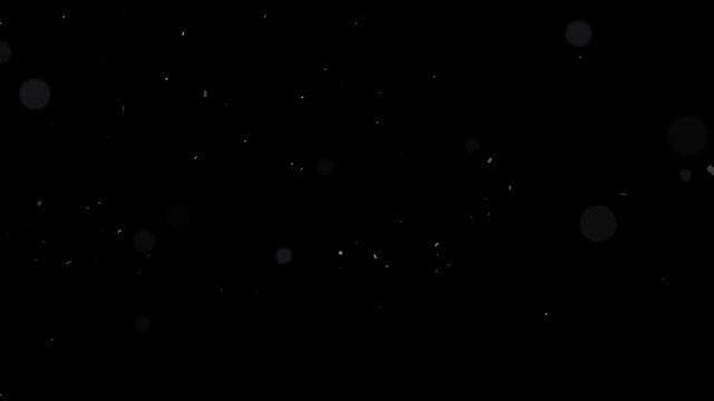 Delicate flying dust motes with soft bokeh effect slowly moving across a dark screen motion background footage