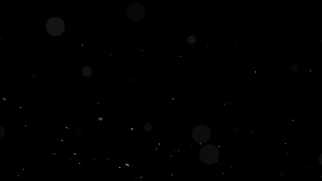Atmospheric light particles slowly float and fall with bokeh effect against a dark background motion