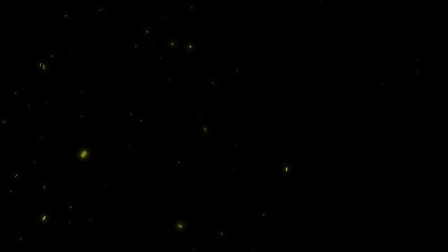 Abstract golden dust particles gently float and rise slowly across a dark background creating a magical atmospheric
