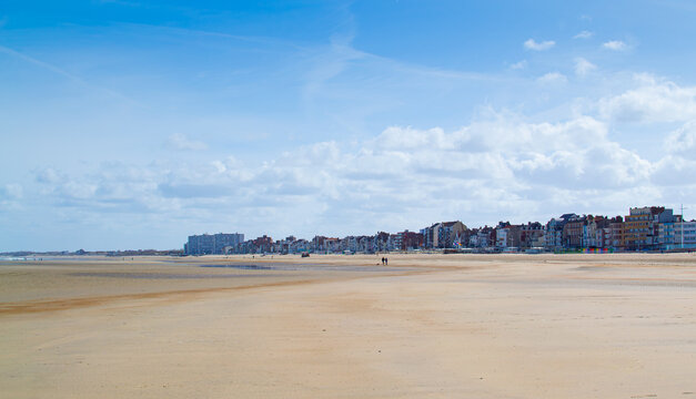 Dunkirk beach, Plage Dunkerque, promenade near the sea, coastline, sand, dunes, Malo-les-Bains, France, La Manche, people walking far away, a large beach known from the Second World War.