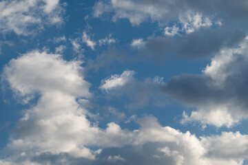 Obraz premium Changing sky with dark clouds. Fierce clouds indicating approaching storm system formation. Dynamic weather scene with swirling clouds foretelling emerging storm front