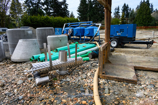 Blue skid-mounted industrial groundwater filtration system, construction site remediation pumping and cleaning excess rain water before sending into municipal system
