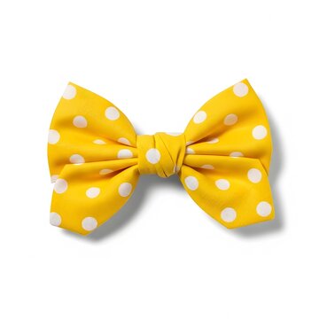 Yellow polka dot bow tie on white background with soft shadow luxury accessory.