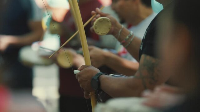 Roda de capoeira musician playing berimbau