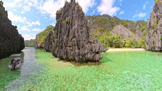 Hidden Beach on Matinloc Island, Palawan, Philippines, reveals clear turquoise water surrounded by towering limestone karsts, creating a secluded tropical lagoon in Philippines