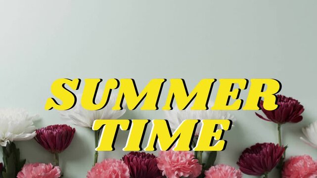 Bold yellow SUMMER TIME text centering in studio while cut flowers extending up mint backdrop