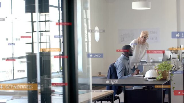 Seated male, standing female coworkers reviewing laptop in office, creating floating notify banners