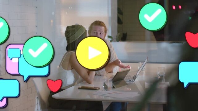Woman and man reviewing ads, pointing at laptop and activating icons on glass as coworker passing