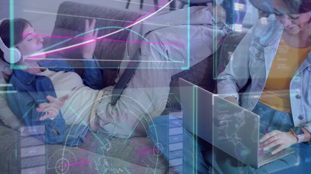 Reclining woman on couch with headset gesturing, seated user typing causing tech HUD charts for fun
