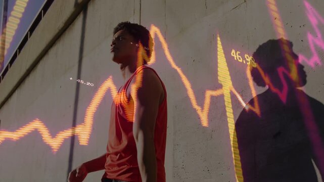 Man raising basketball shifting to dribbling by wall training as waveform pulsing numbers over him