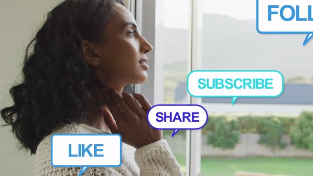 Mid-adult woman reflecting, moving hand to neck at window, causing social media bubbles stacking