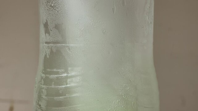 Time-lapse footage of frozen ice water melting naturally at room temperature.