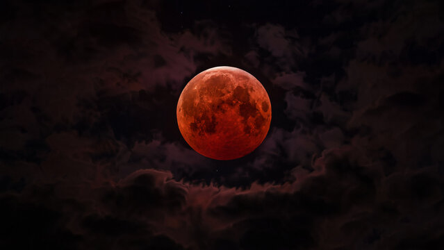 Total Lunar Eclipse Blood Moon in Dark Cloudy Night Sky