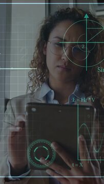 Vertical video: Woman tapping tablet in office running tech HUD, Km or h readouts fluctuating, smili