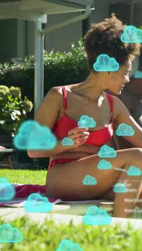 Vertical video: Woman in red raising cup by pool, sparking HTML and turquoise clouds for marketing