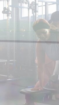 Vertical video: Coach giving cue, client doing dumbbell rows, motion arrows fixing form for fitness