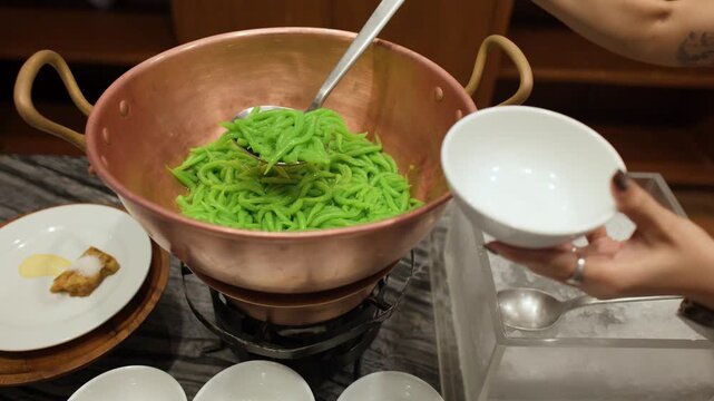 Serving Traditional Thai Pandan Noodles Lod Chong from a Copper Pot