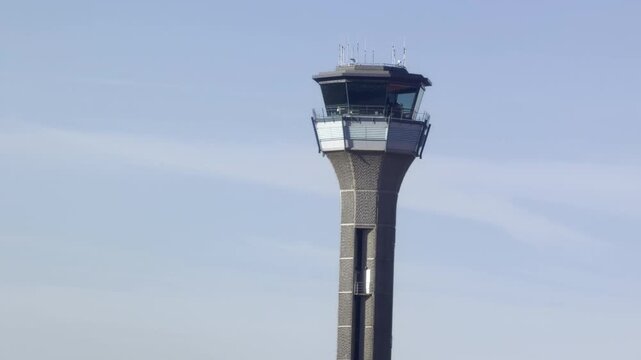 Air traffic control tower against blue sky
